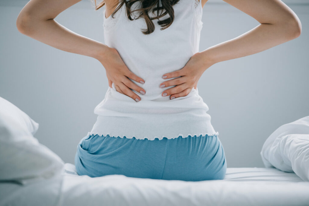 back view of young woman in pajamas suffering from BSEVEEF