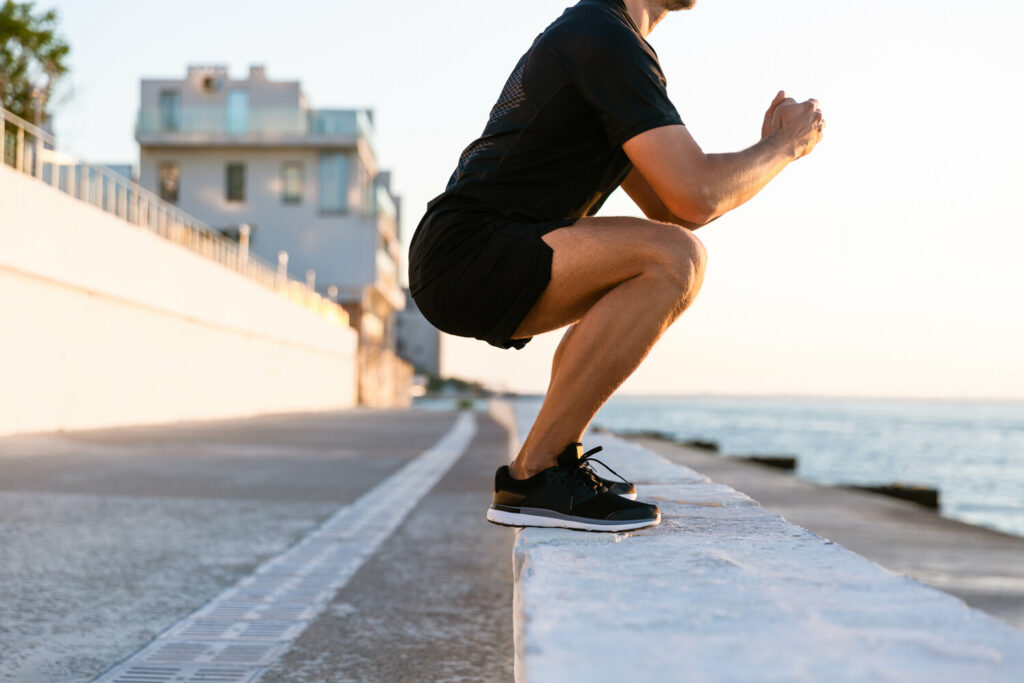 cropped shot of sportsman standing squats on parap AYRJQUR