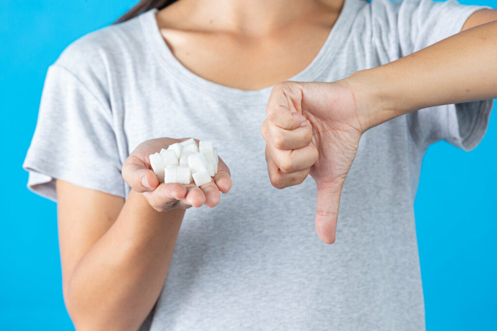 world diabetes day hand holding sugar cubes thumb down another hand